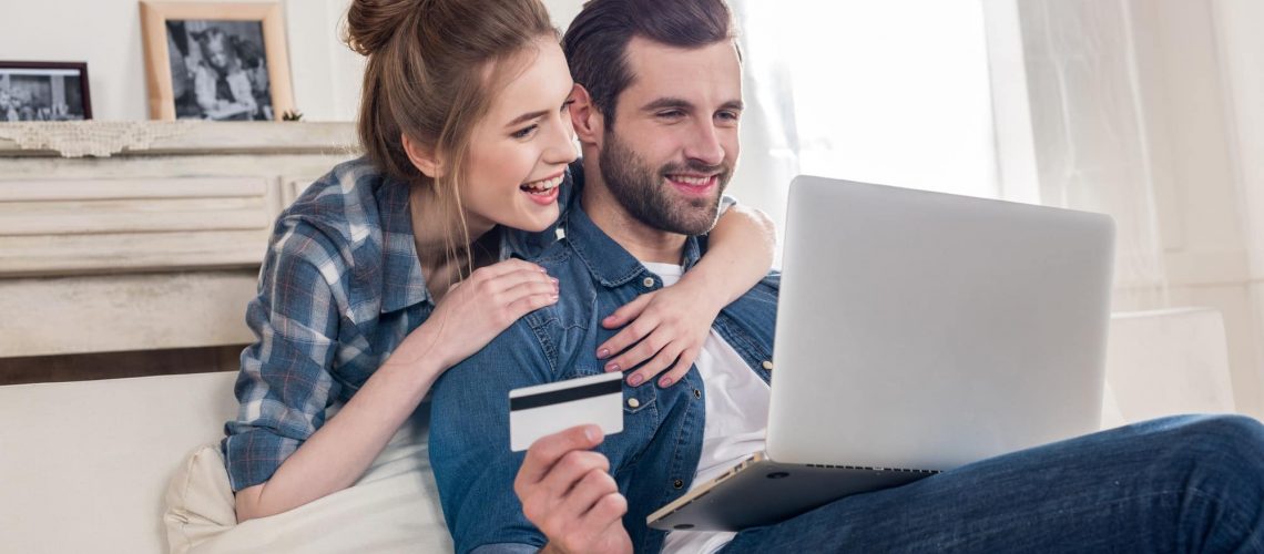 young-couple-making-online-payment-using-credit-card-and-laptop.jpg